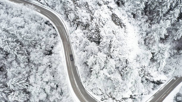 istock Car driving on winter country road 1357902916