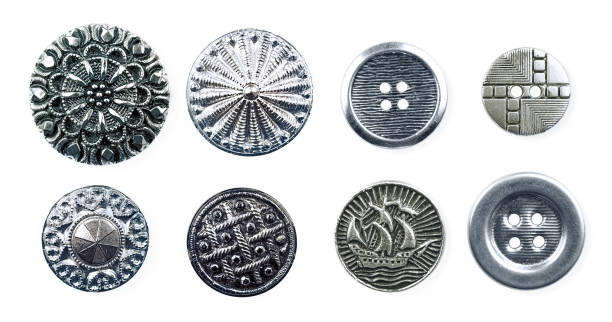 A set for creativity - metal press-stud and buttons. Beautiful textured metal buttons with ornaments and pictures of the silver color close-up macro. button sewing item stock pictures, royalty-free photos & images