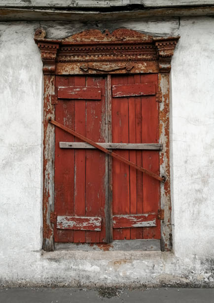 the old window is closed. old wooden window sashes. peeling paint. - mullion windows imagens e fotografias de stock