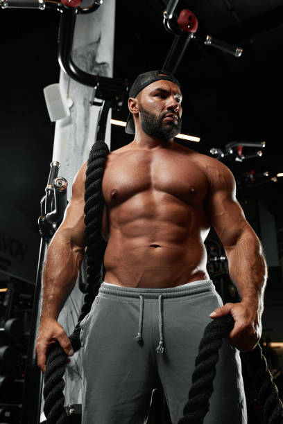 istock Brutal handsome Caucasian bodybuilder working out training in the gym gaining weight pumping up muscles and poses fitness and bodybuilding concept 1357906229