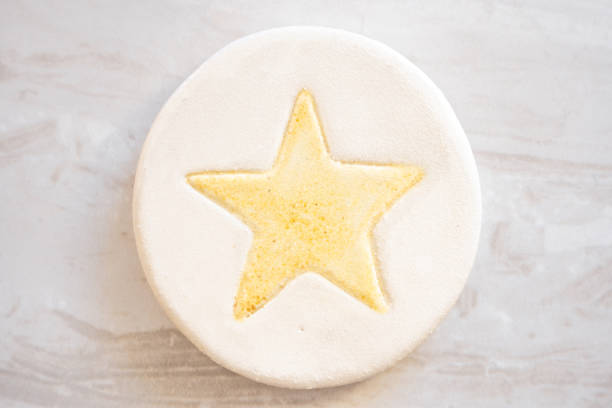 Ceramic Christmas Decoration Coaster with a golden star on a White Background stock photo