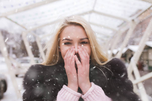 istock surprised lady walking at the holiday fair during snow 1357907361