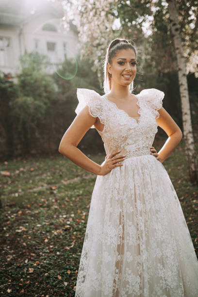 istock Bride in white wedding dress walks through autumn forest 1357907893