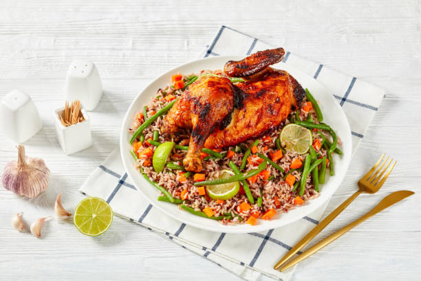 istock Charcoal Grilled Chicken with Veggie Fried brown and wild Rice on a platter 1357908589