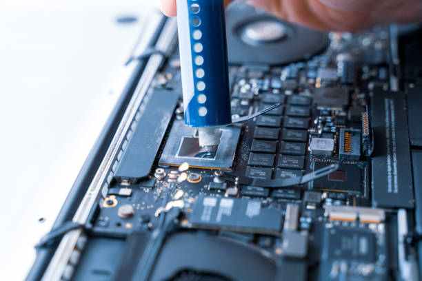 istock Computer maintenance. Pc technician repair service with laptop on hardware background. Maintenance engineer support. Electronic technology development concept. 1357910284