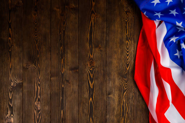 istock crumpled usa flag on flat textured wooden surface background 1357911233