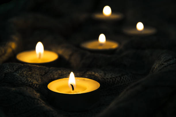 istock Burning candles and a warm knitted winter blanket 1357911264