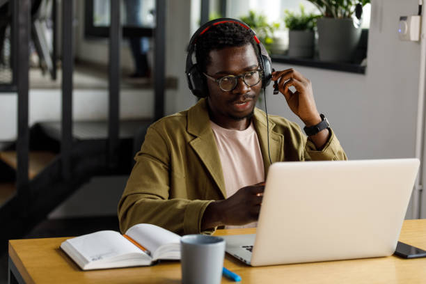 istock Diligent young businessman wearing a headset and explaining his ideas to a business partner via video call 1357911448