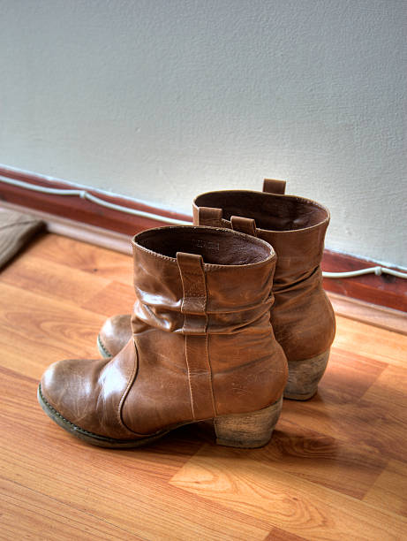istock Women's leather boots wood floor 135791168
