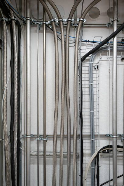 istock Industrial wall mounted vertical running stainless aluminum pipes 1357911841