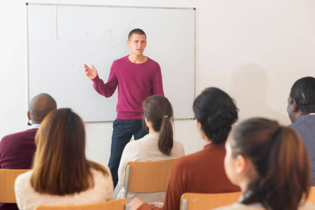 istock Teacher at university in front of chalkboard with multinational students 1357911852