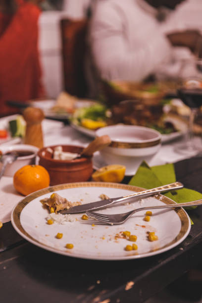Close up shot of empty plate on a wooden table after a person enjoyed a delicious Christmas day meal with friends.