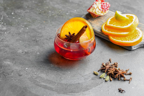 istock Mulled wine with different spices and fruit on rustic background. Winter time beverage  concept. Copy space. 1357914052