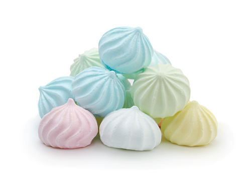 Heap of fresh multicolored meringues isolated on white.
