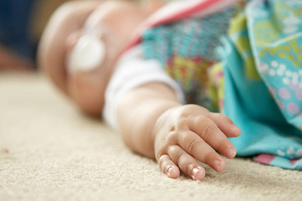 istock Three month old baby on carpet hand focus 135791712