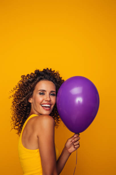 istock Beautiful woman holding a balloon 1357922467