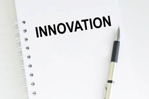 istock text INNOVATION on a white notepad with a pen on the table. Business concept 1357924052