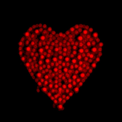 Glittering red heart on a black background.