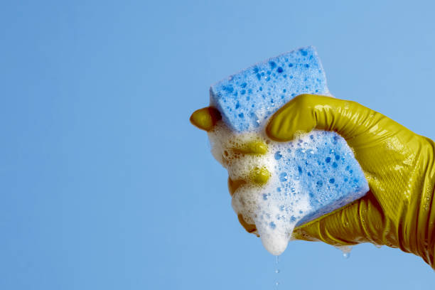istock Hand holding a cleaning sponge with soap sud 1357928792