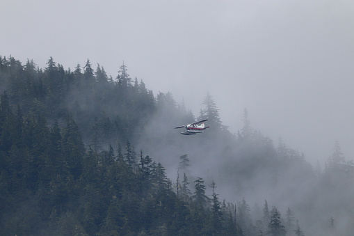 Float plane flying in fog in Alaska