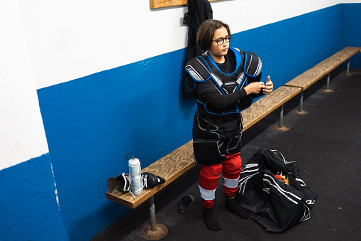 boy getting ready to practice hockey