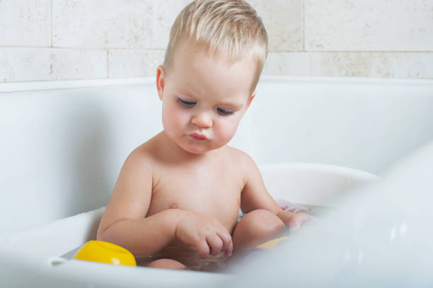 istock Toddler boy bathes in bathroom close-up.. 1357931705