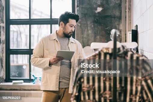 istock Shop manager making a inventory 1357935227
