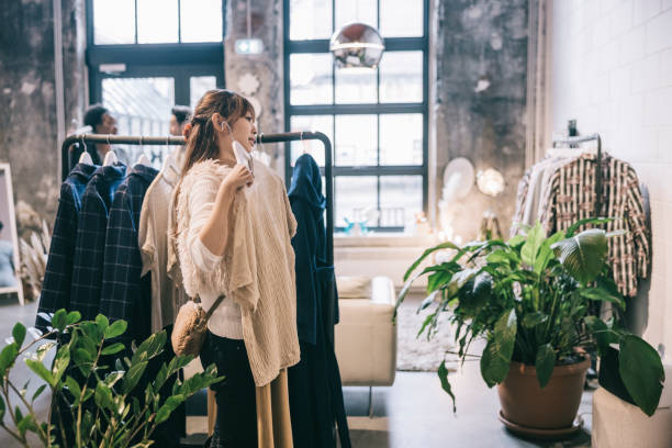 istock Asian woman shopping for clothes 1357935233