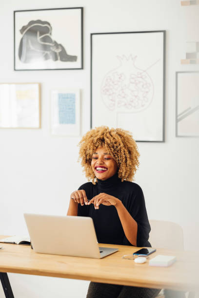 istock Beautiful African American Woman Using her Laptop While Working from Home 1357935446