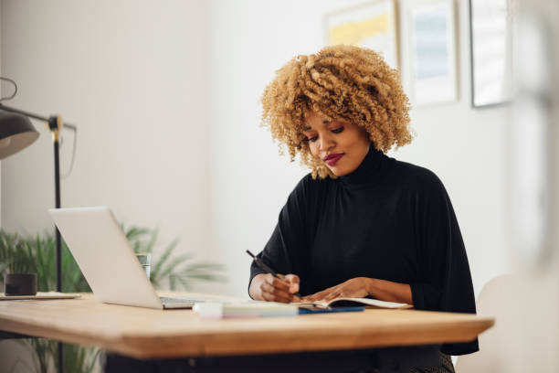 istock Beautiful Businesswoman Writing Notes for Work 1357935458