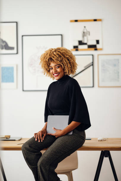 istock Happy Businesswoman Sitting on Her Desk Using Her Tablet 1357935557