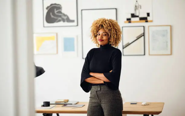 Photo of Confident Beautiful Woman Standing in her Home Office