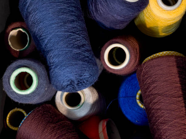 istock Top view of colored yarn threads on bobbins 1357940762