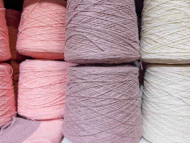 istock Set of pink yarn threads on bobbins 1357941011