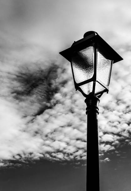 istock Vintage street lamppost under cloudy sky 1357941033