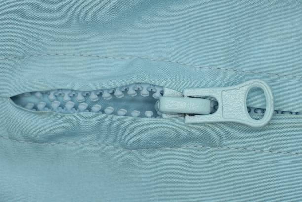 Blue zipper on a blue windbreaker jacket.