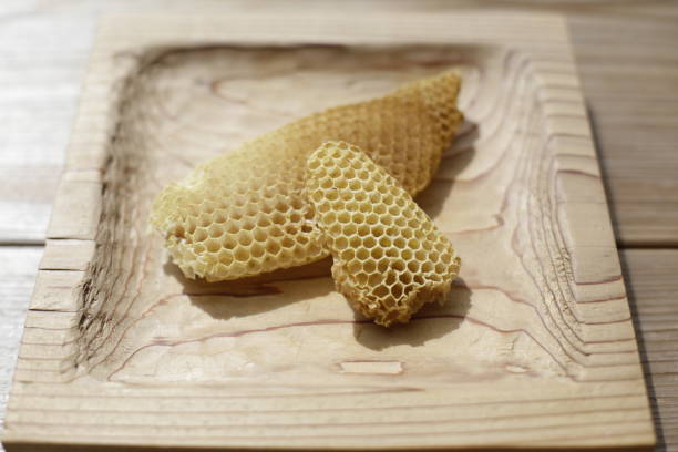 istock Honeycomb pieces on wooden tray. Burr comb. 1357942997