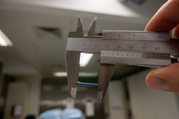 istock blue titanium screw is measured with a caliper gauge 1357943625