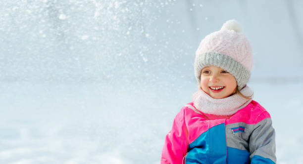 istock A kid have fun playing in the snow in winter 1357944611