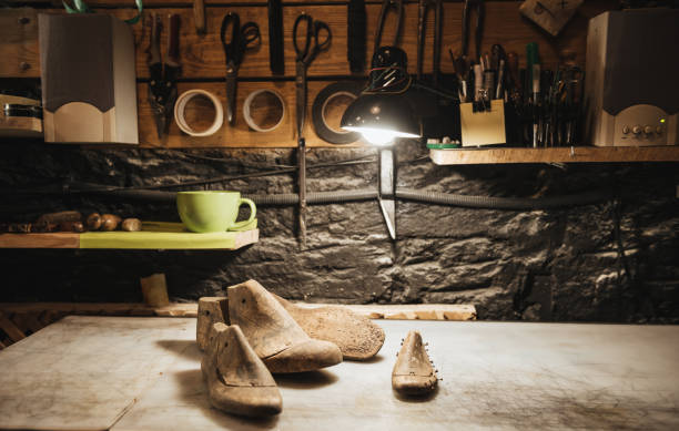 Shoes on table at footwear workshop. Picture of shoes on table at footwear workshop. diy table legs stock pictures, royalty-free photos & images