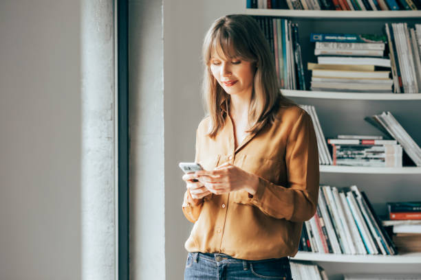 istock Smiling Businesswoman Using Mobile Phone 1357948431