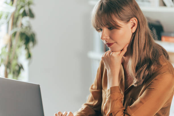 istock Smiling Businesswoman Working on Laptop Computer 1357948433