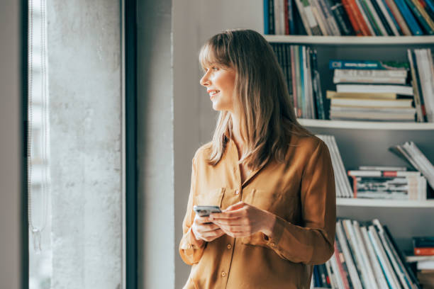 istock Smiling Businesswoman Using Mobile Phone 1357948435