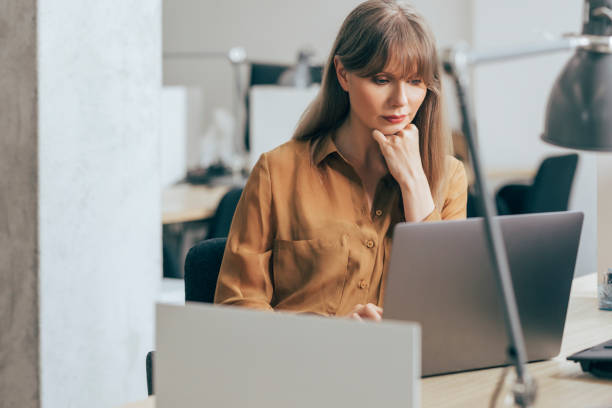 istock Smiling Businesswoman Working on Laptop Computer 1357948456