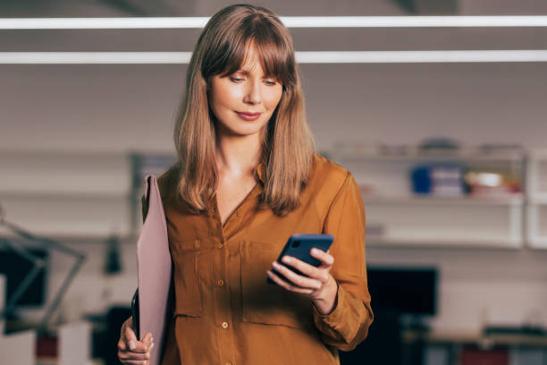 istock Smiling Businesswoman Using Mobile Phone 1357948462