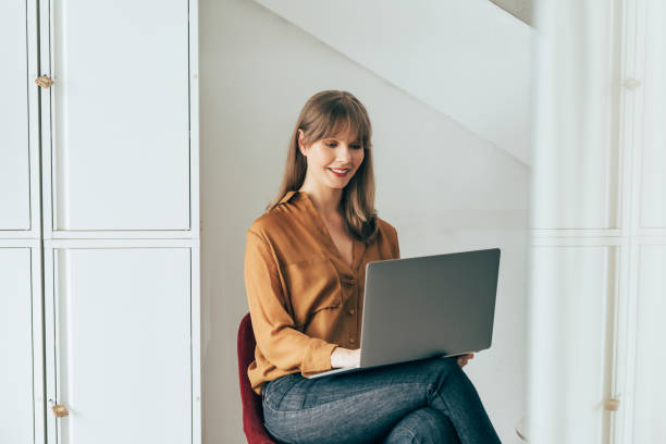 istock Smiling Businesswoman Working on Laptop Computer 1357948471