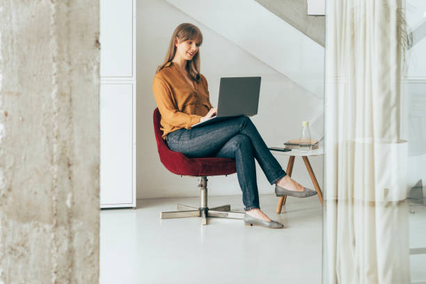 istock Smiling Businesswoman Working on Laptop Computer 1357948473