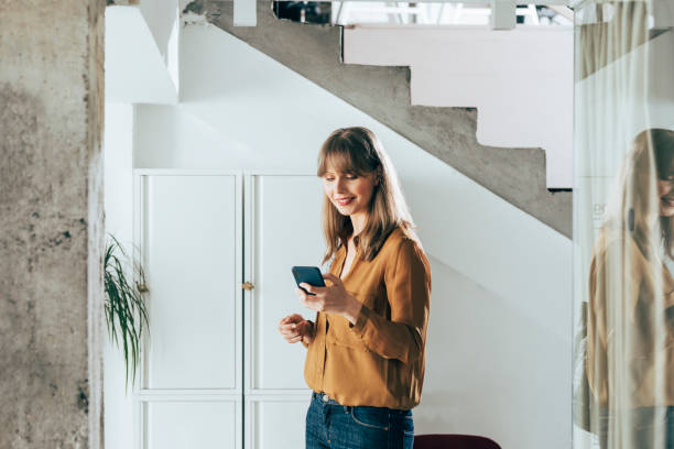 istock Smiling Businesswoman Using Mobile Phone 1357948481