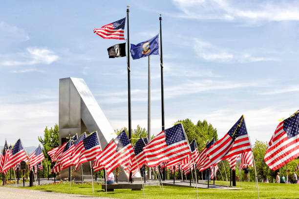 Flags flying at the state memorial honoring the Idaho Citizens who fought and died in the Vietnam war.  American flags surround the memorial, located in Freeman Park, in Idaho Falls Idaho.