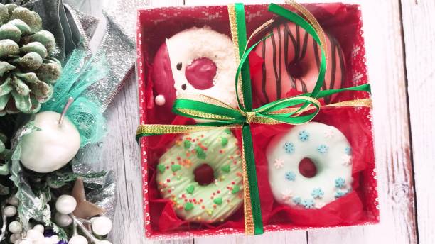 istock unpacking a christmas donut box, donuts with icing and sprinkles 1357952585